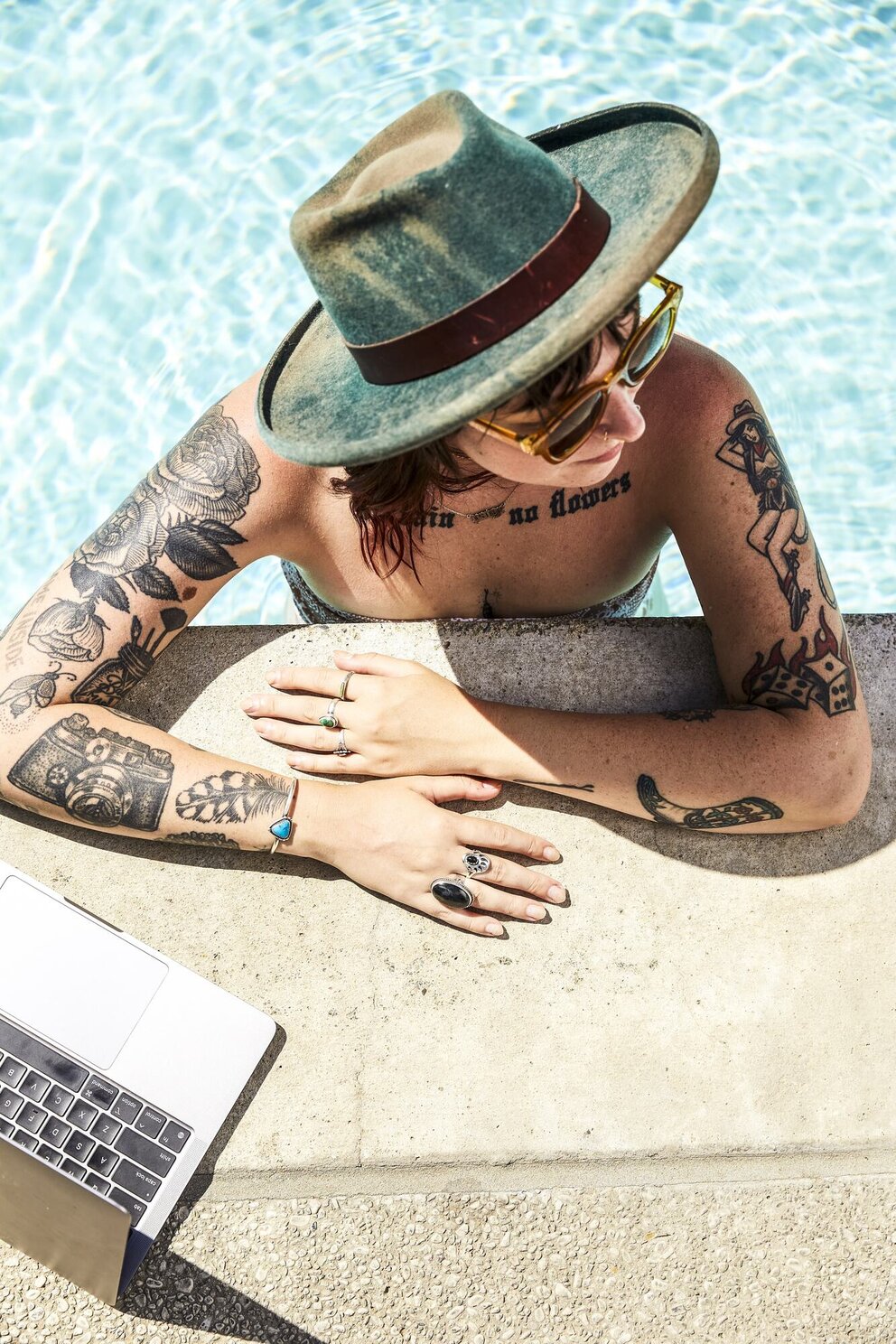 woman in pool with laptop
