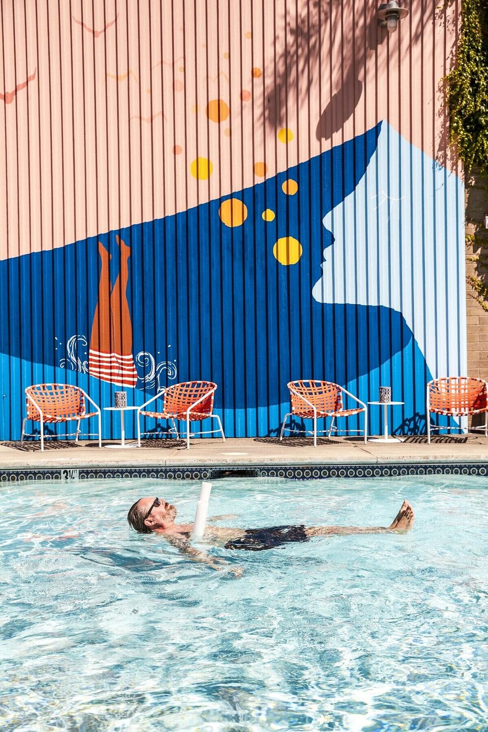 person floating in pool