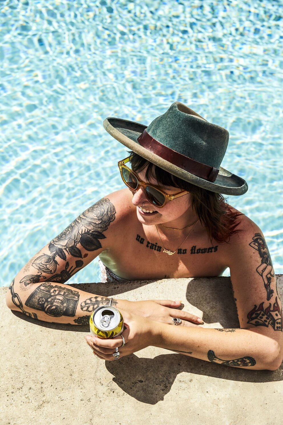 person in pool with drink